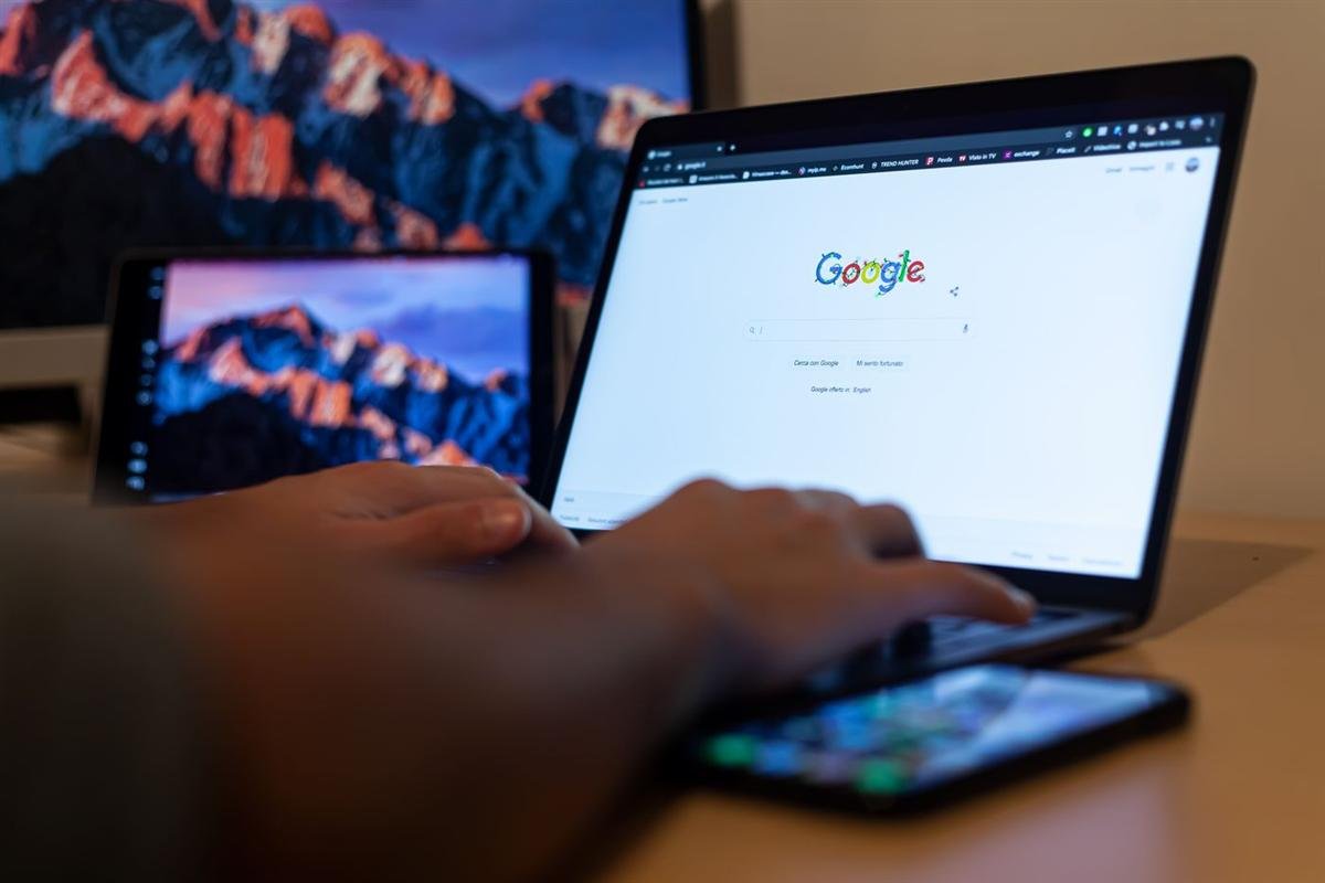 Hands typing on a laptop with Google open on the screen