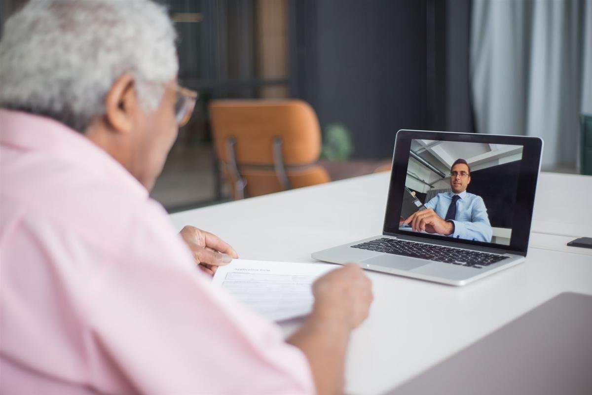 Consultant discussing a project over a video call on a laptop
