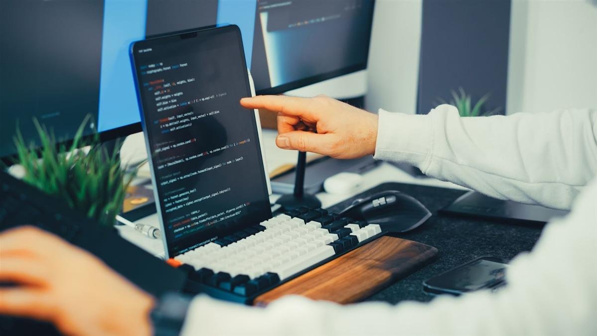 Developer reviewing website code on a screen