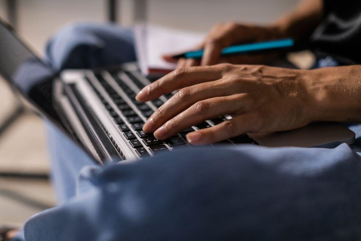 Writer typing content on a laptop