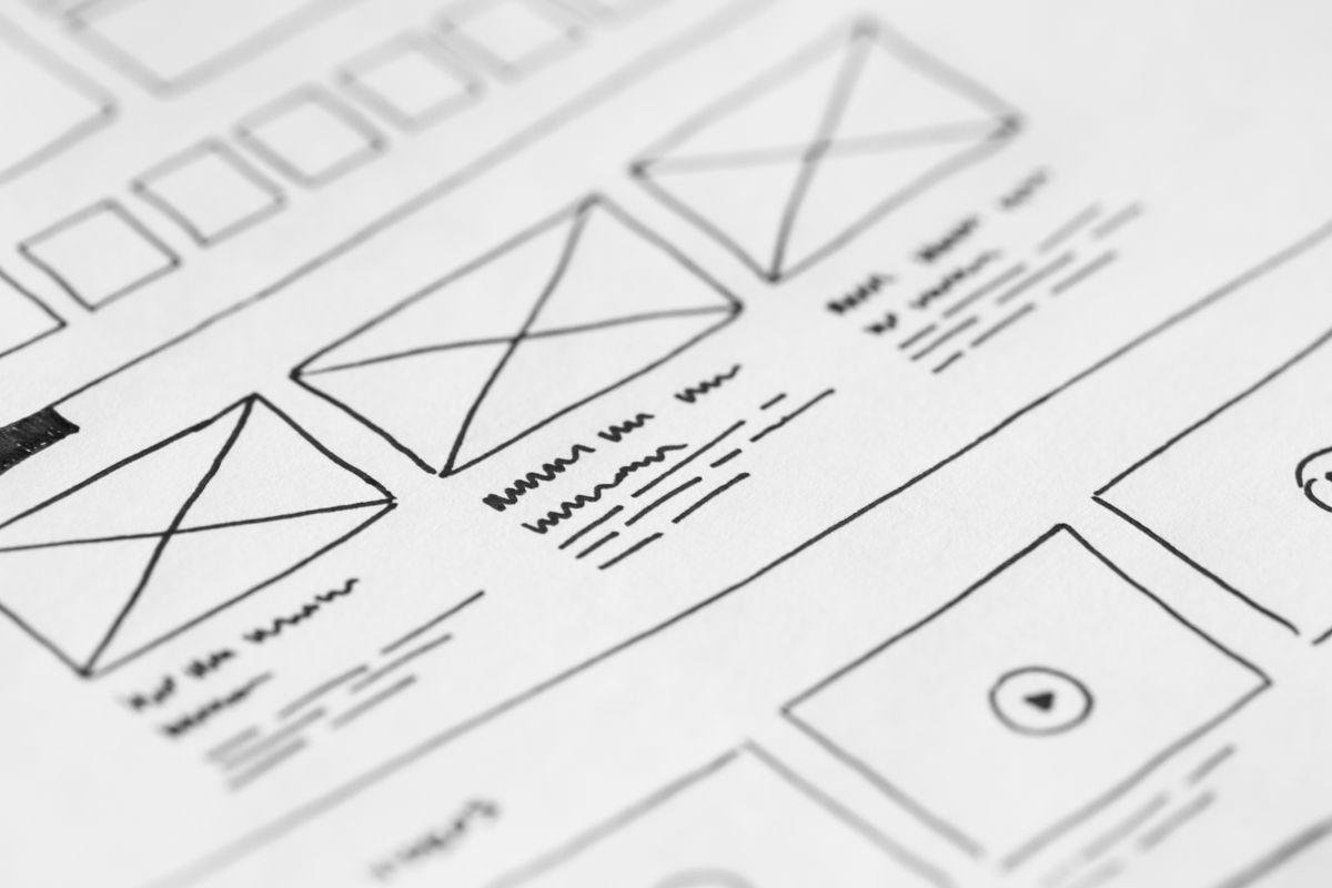 Designer reviewing hand-drawn website wireframes